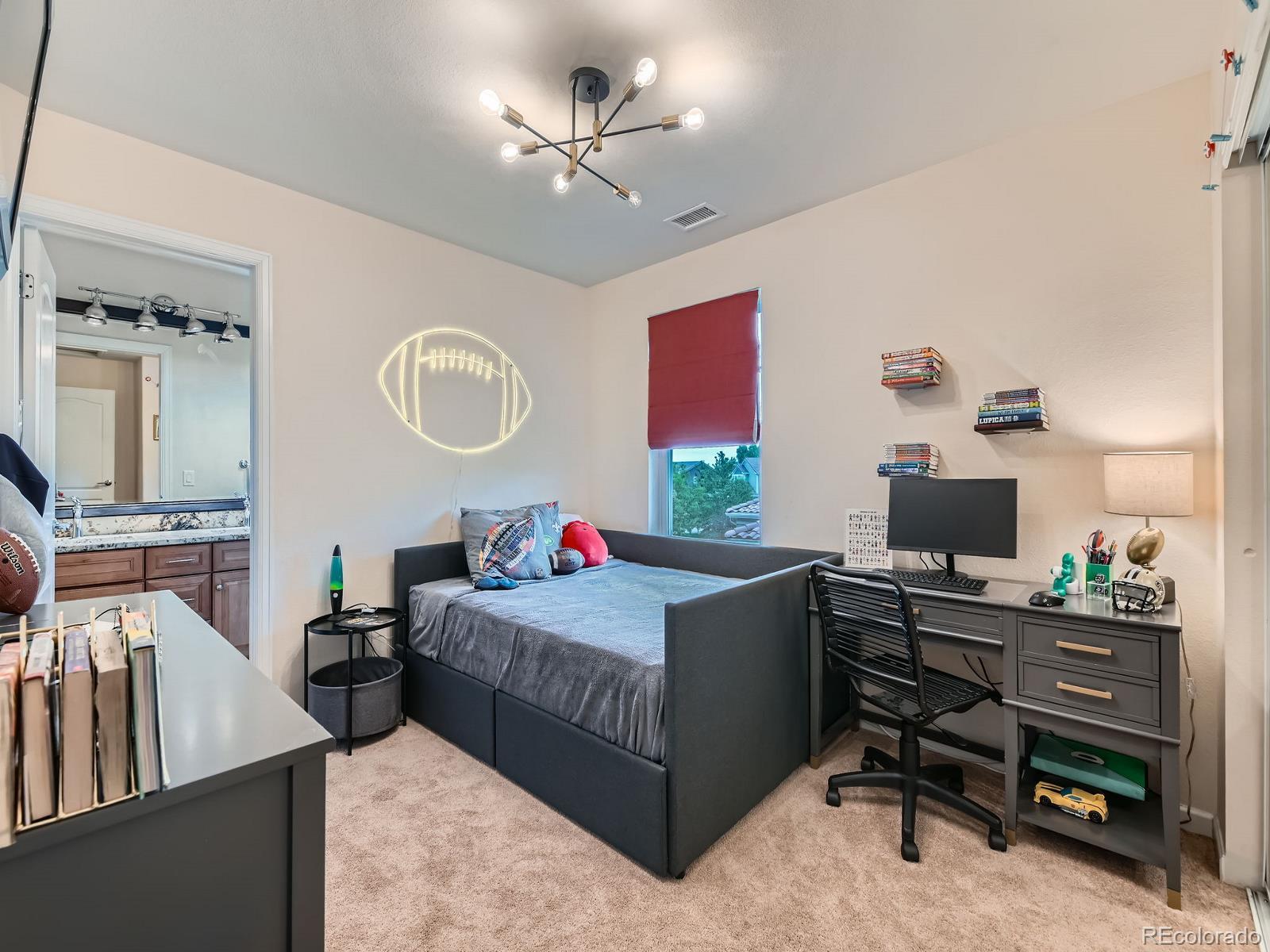 2896 Gemini Loop Broomfield, CO 80023 - Photo 28 of 49 a living room with furniture and a flat screen tv