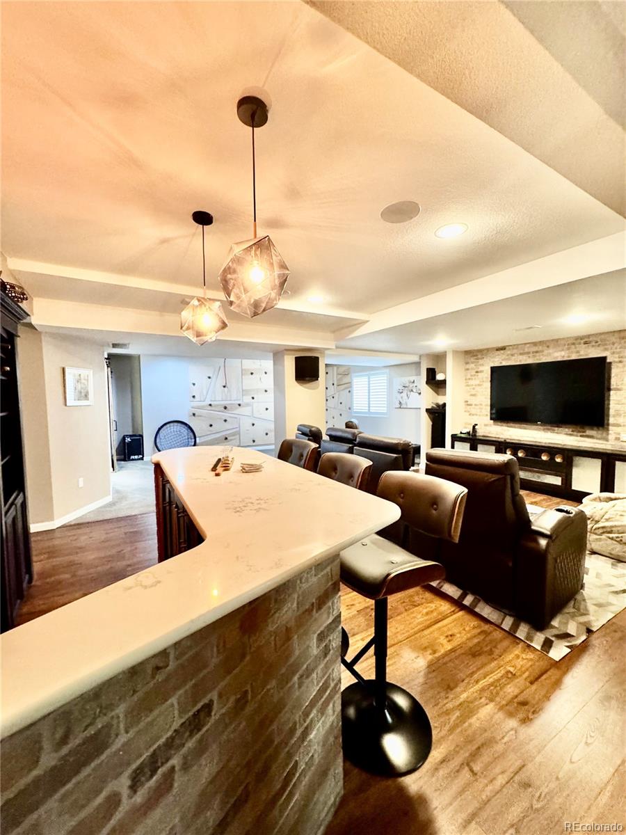 2896 Gemini Loop Broomfield, CO 80023 - Photo 30 of 49 a living room with furniture and a flat screen tv
