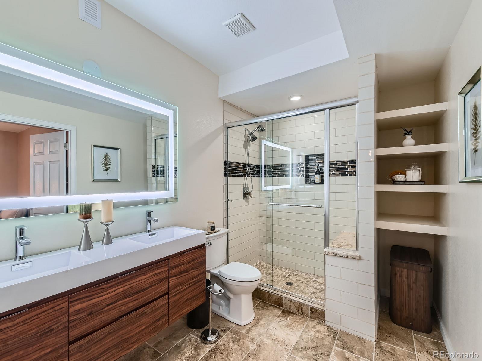 2896 Gemini Loop Broomfield, CO 80023 - Photo 36 of 49 a bathroom with a toilet a sink and mirror