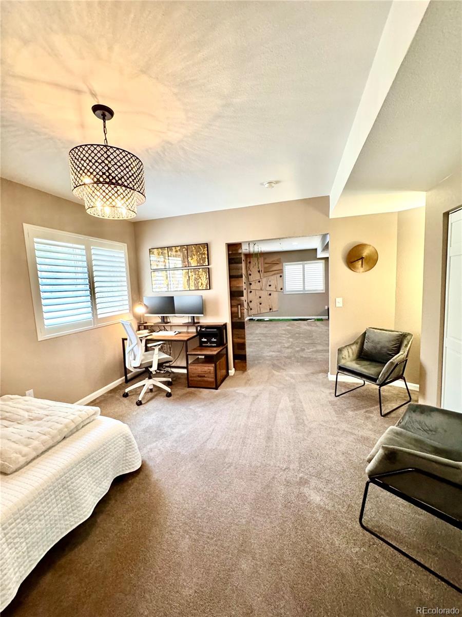 2896 Gemini Loop Broomfield, CO 80023 - Photo 37 of 49 a bedroom with furniture and a large window