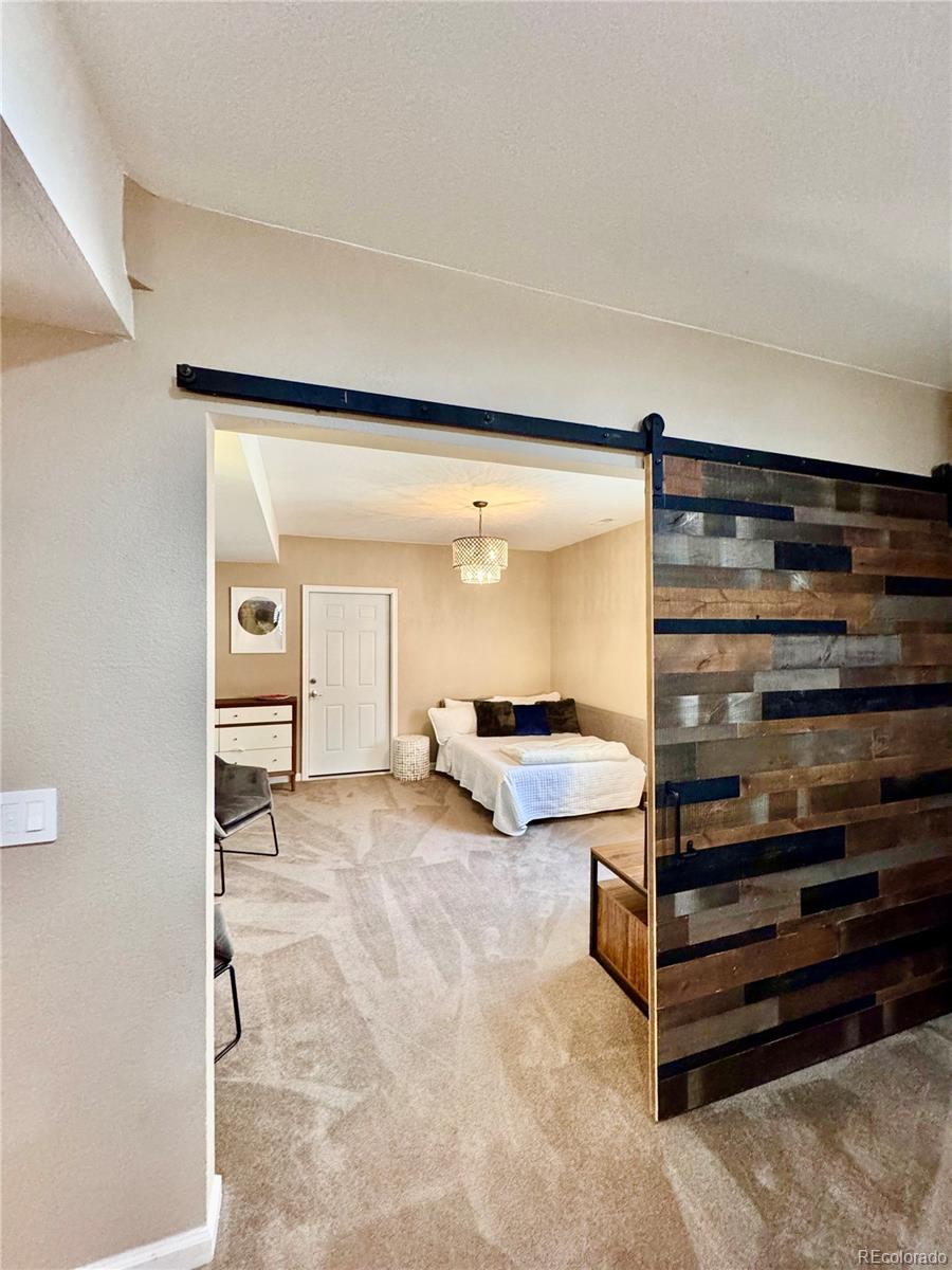 2896 Gemini Loop Broomfield, CO 80023 - Photo 39 of 49 a view of a room with gym equipment and a ceiling fan