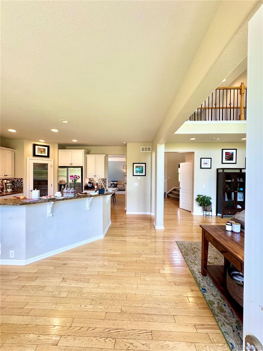 2896 Gemini Loop Broomfield, CO 80023 - Photo 10 of 49 a view of a living room kitchen and a stove