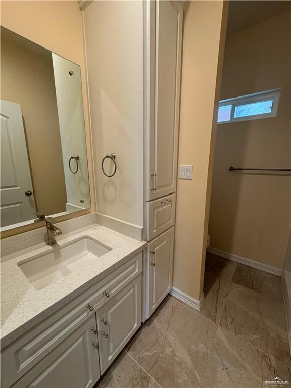 1114 North 20th Street McAllen, TX 78501 - Photo 12 of 27 a bathroom with a sink and a mirror