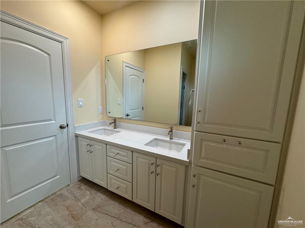 1114 North 20th Street McAllen, TX 78501 - Photo 14 of 27 a spacious bathroom with a double vanity sink and mirror