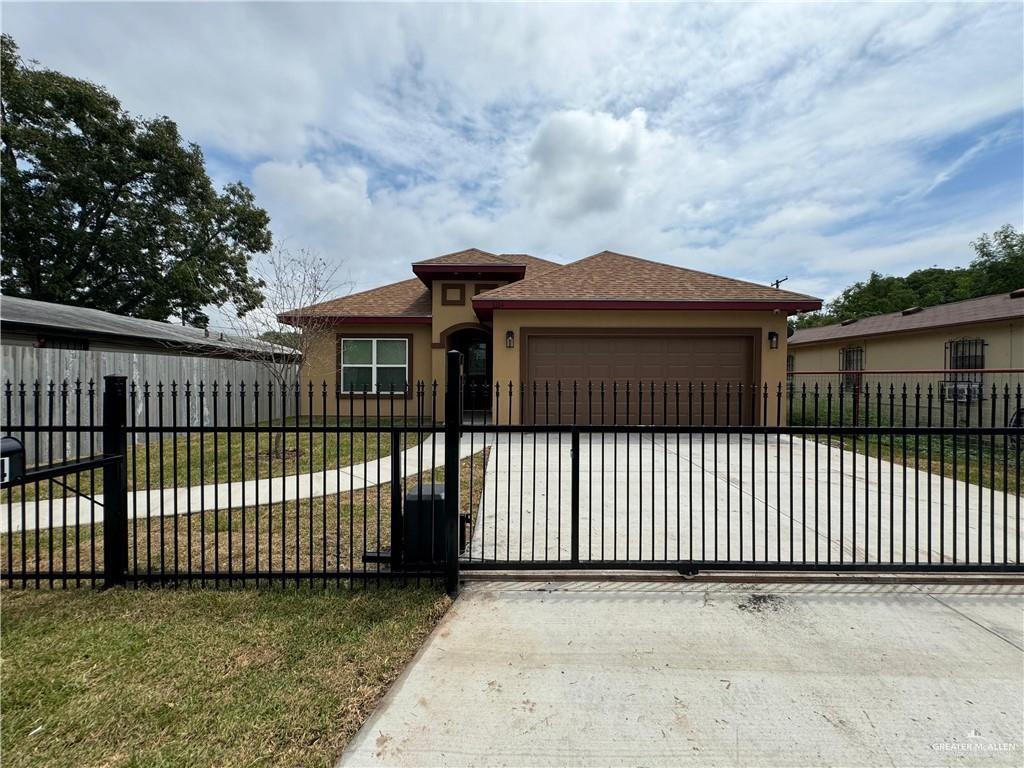 1114 North 20th Street McAllen, TX 78501 - Photo 2 of 27 a front view of a house having yard