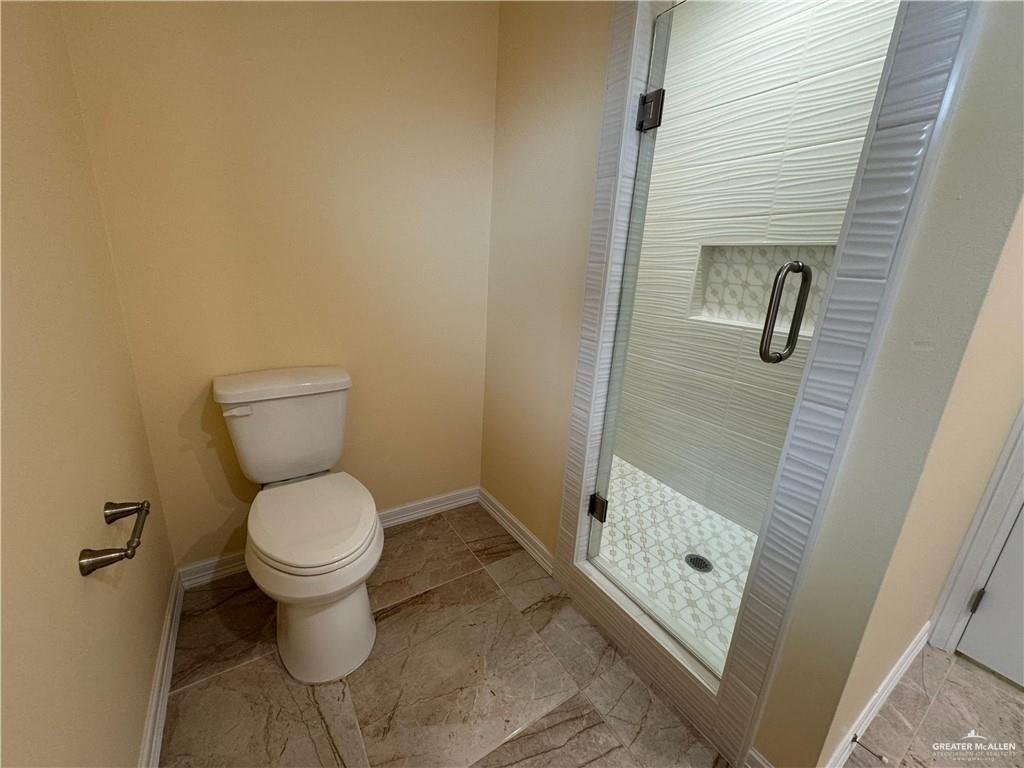 1114 North 20th Street McAllen, TX 78501 - Photo 10 of 27 a bathroom with a toilet and a shower
