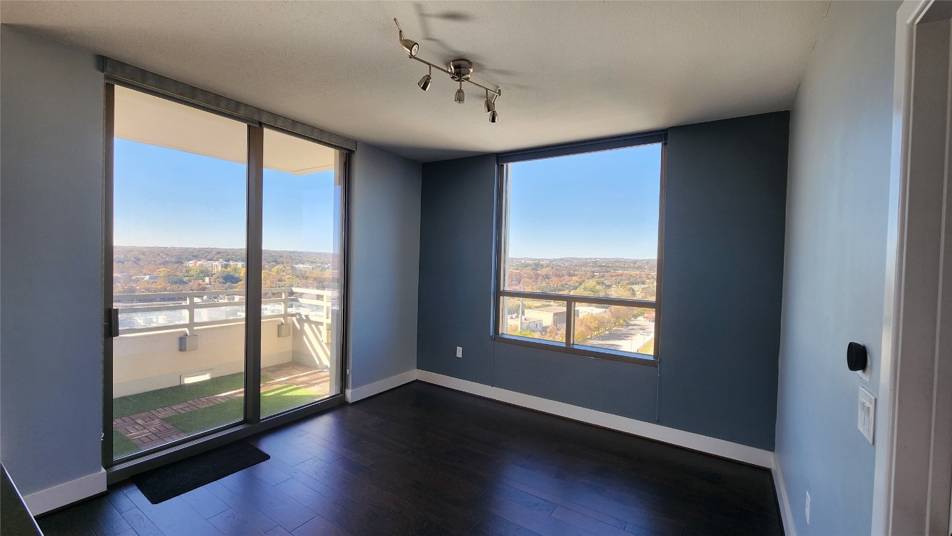 300 Bowie Street, Unit 1305 Austin, TX 78703 - Photo 8 of 38 a view of an empty room with wooden floor and a window
