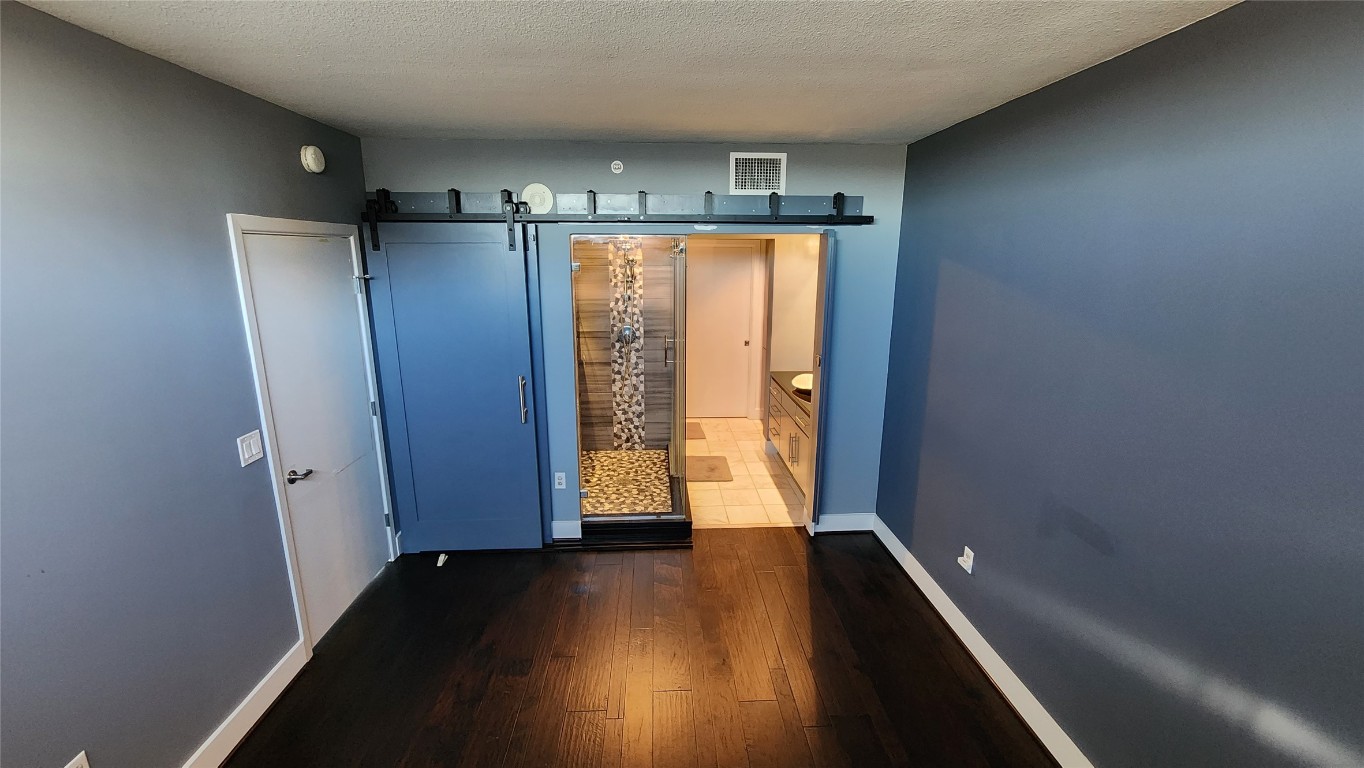 300 Bowie Street, Unit 1305 Austin, TX 78703 - Photo 14 of 38 a view of walk in closet with wooden floor