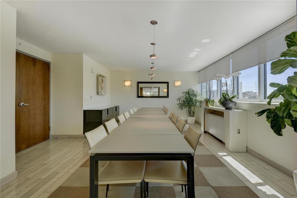 300 Bowie Street, Unit 1305 Austin, TX 78703 - Photo 30 of 38 a view of a dining room with furniture and wooden floor