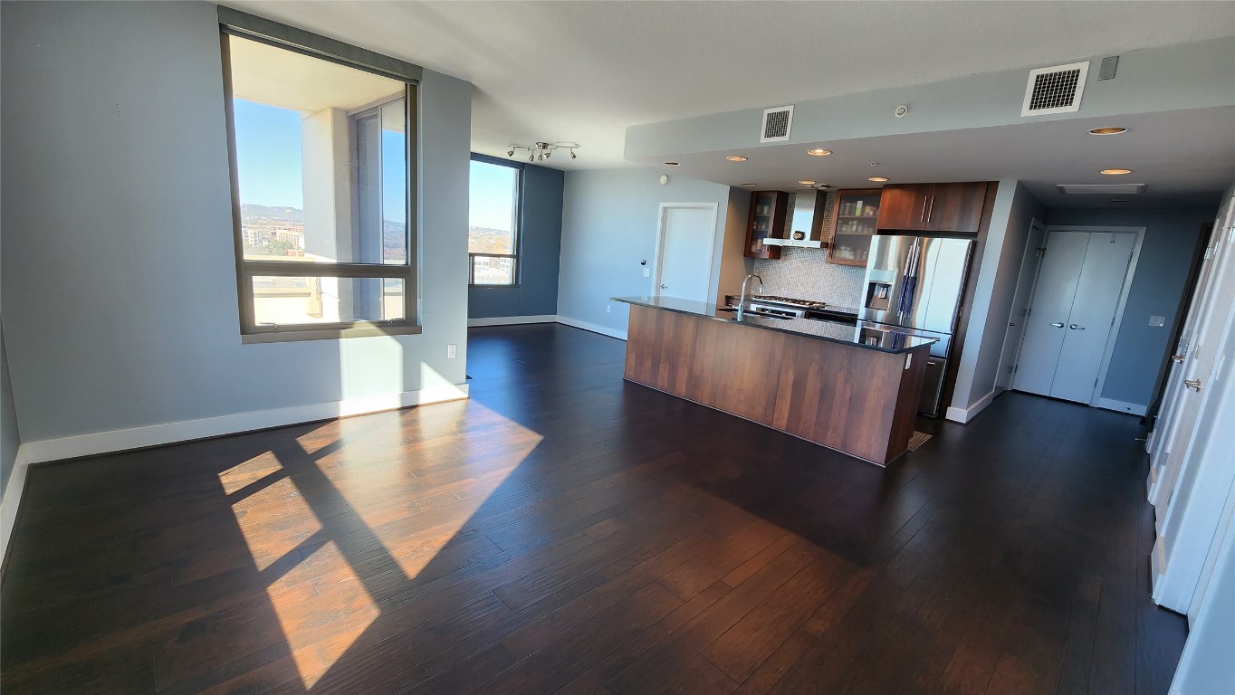 300 Bowie Street, Unit 1305 Austin, TX 78703 - Photo 38 of 38 a view of a living room with kitchen view and a wooden floor