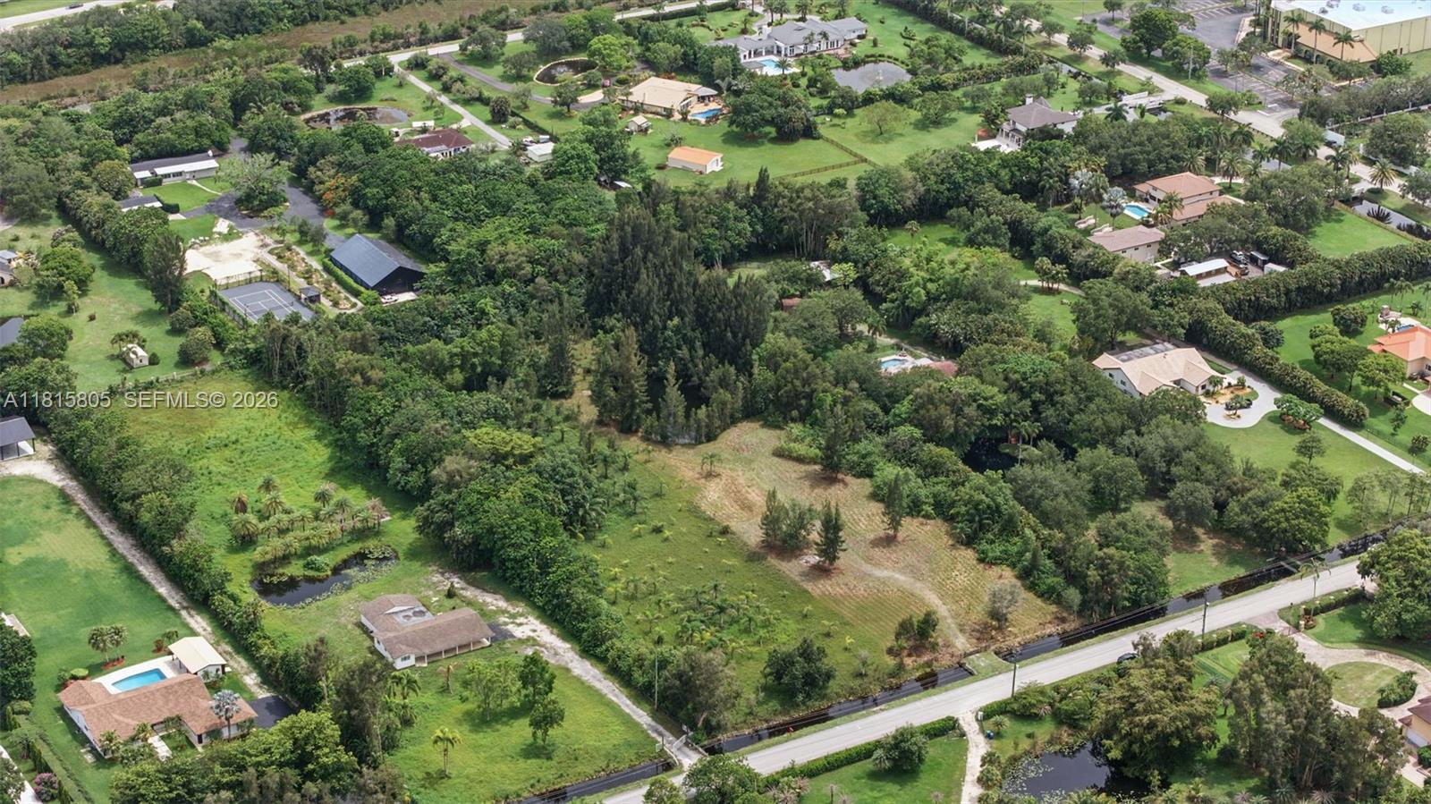 14020 Mustang Trail Southwest Ranches, FL 33330 - Photo 7 of 9 an aerial view of residential houses with outdoor space and trees