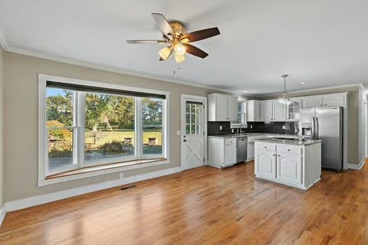 a kitchen with white cabinets and appliances