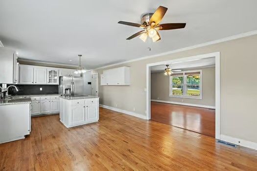 a kitchen with a refrigerator and white cabinets