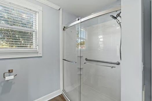 a bathroom with a glass shower door
