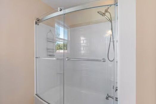 a bathroom that has a glass shower door