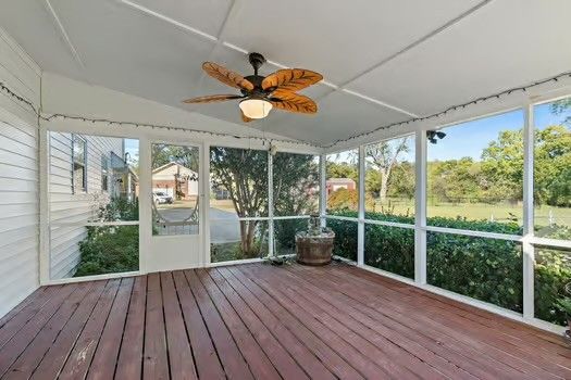 a view of a room with wooden floor and furniture
