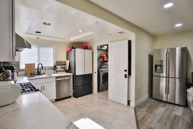 a kitchen with refrigerator and cabinets