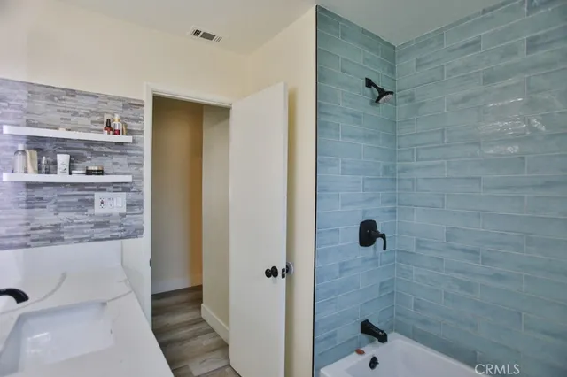 a bathroom with a shower and a sink