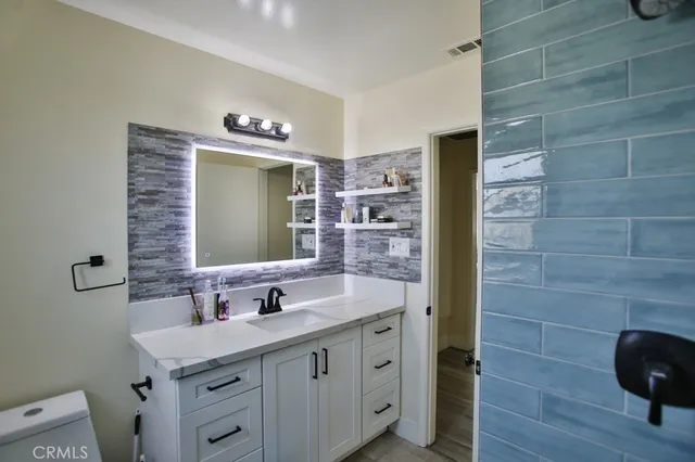 a bathroom with a sink a mirror and shower