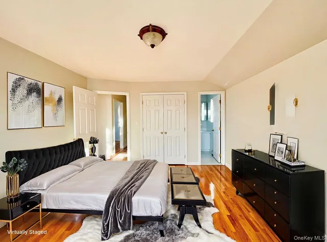 a bedroom with a bed and wooden floor