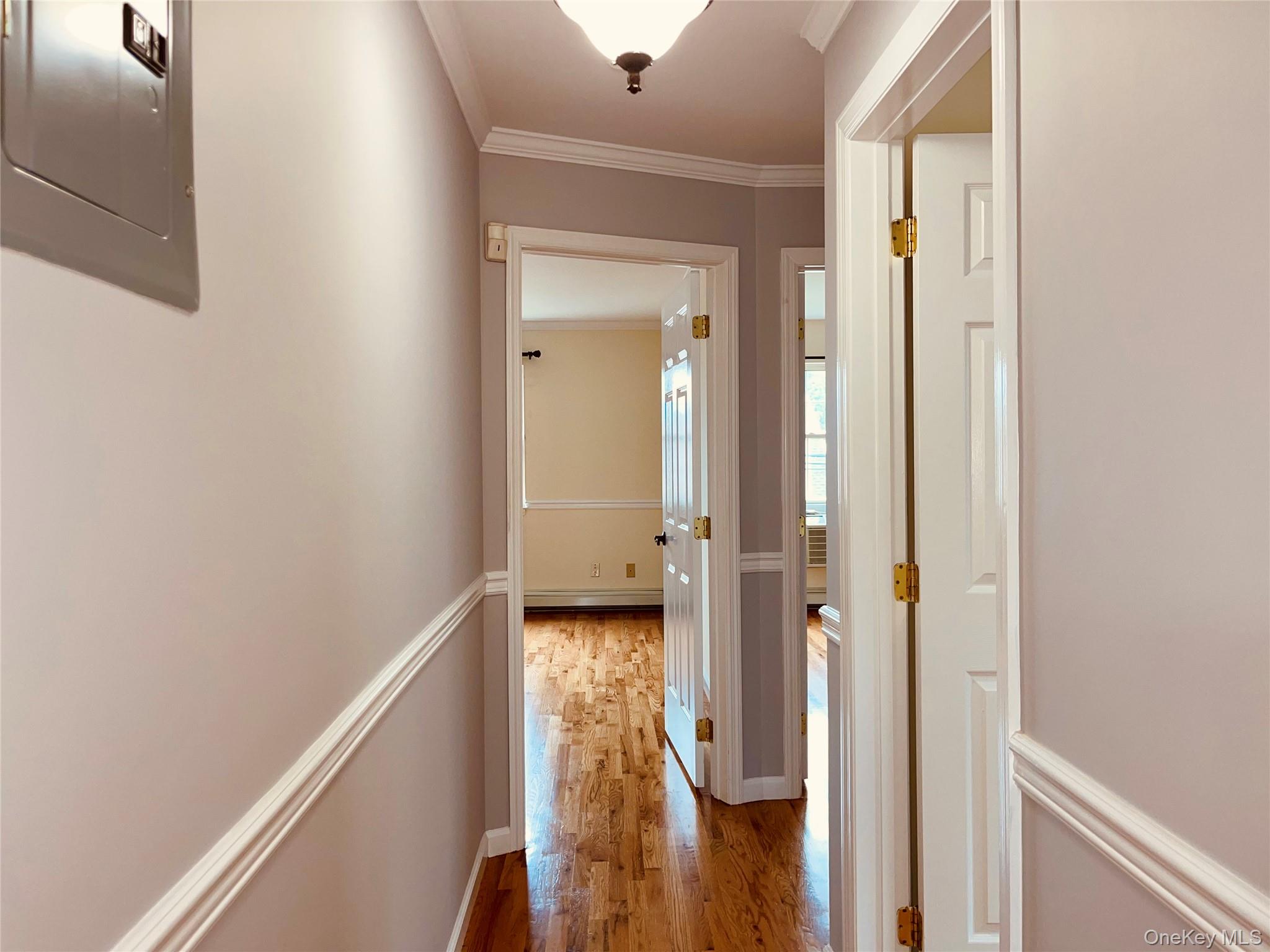 Undisclosed Address Queens, NY 11361 - Photo 7 of 8 a view of a hallway with wooden floor and staircase