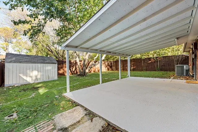 a view of a house with backyard and a tree