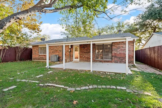 a view of a house with a yard and a garden