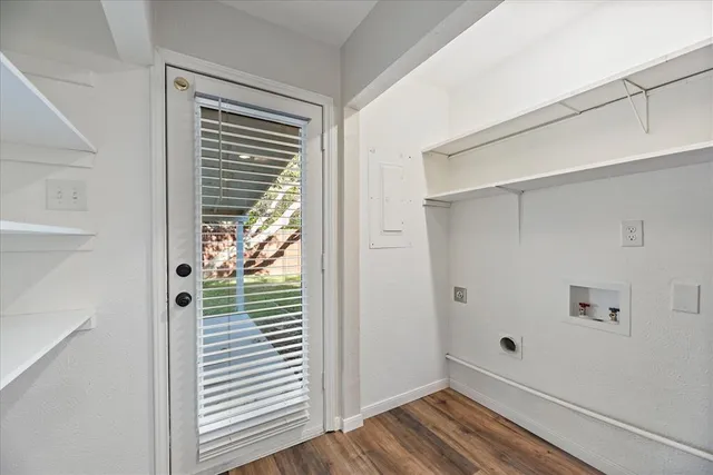 a view of a hallway with wooden floor and closet