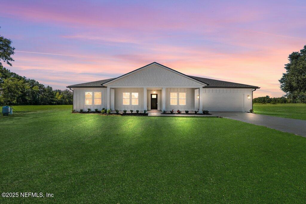 a front view of a house with a garden