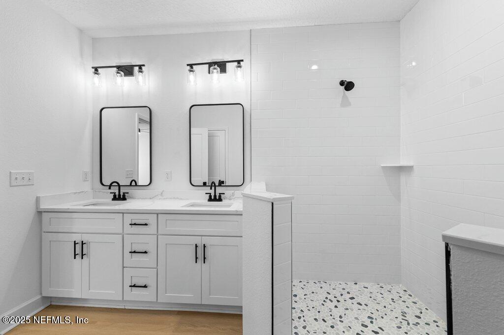 14299 Saddle Ridge Road Macclenny, FL 32063 - Photo 19 of 35 a bathroom with double sink and mirror