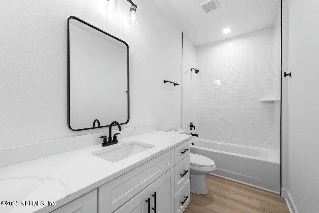 14299 Saddle Ridge Road Macclenny, FL 32063 - Photo 26 of 35 a bathroom with a sink a toilet and shower