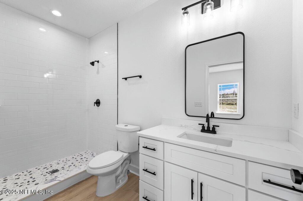 14299 Saddle Ridge Road Macclenny, FL 32063 - Photo 29 of 35 a bathroom with a sink a toilet and shower