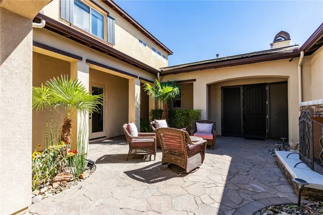 a view of a patio with a table chairs and a potted plant