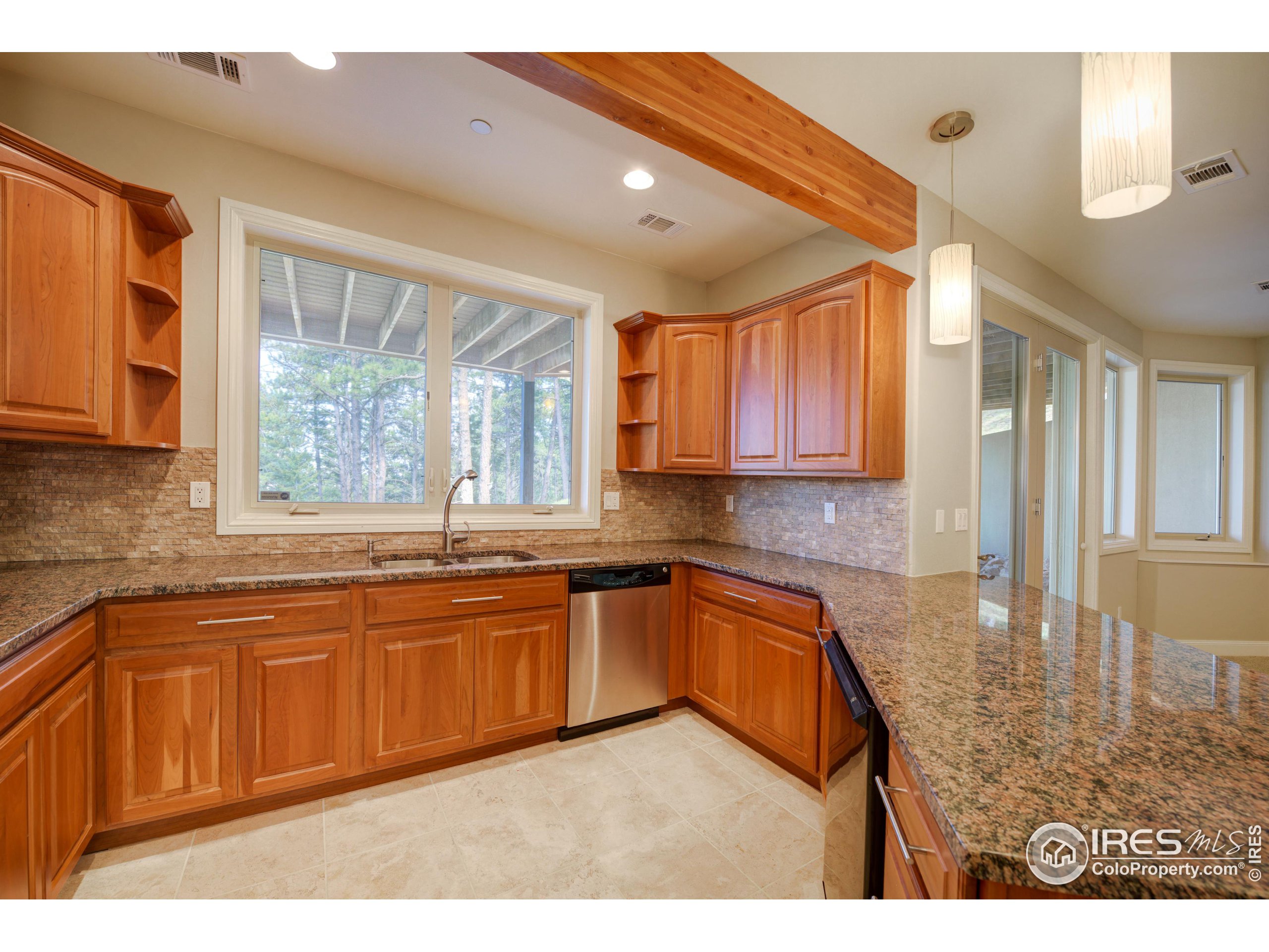 75 Alder Lane Boulder, CO 80304 - Photo 30 of 40 a kitchen with stainless steel appliances granite countertop a sink dishwasher stove and cabinets with wooden floor