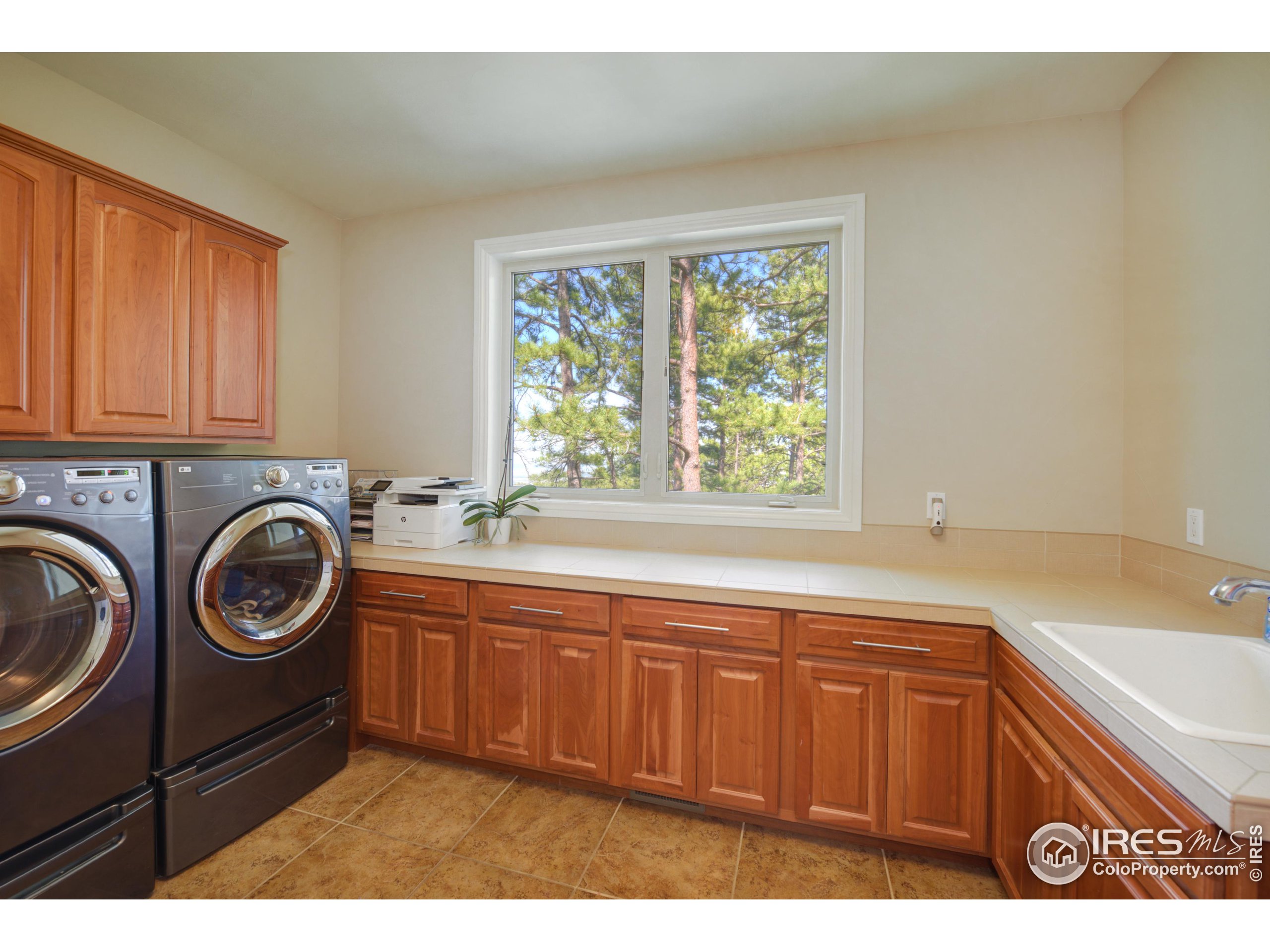 75 Alder Lane Boulder, CO 80304 - Photo 33 of 40 a bathroom with a sink a washer and dryer next to a window