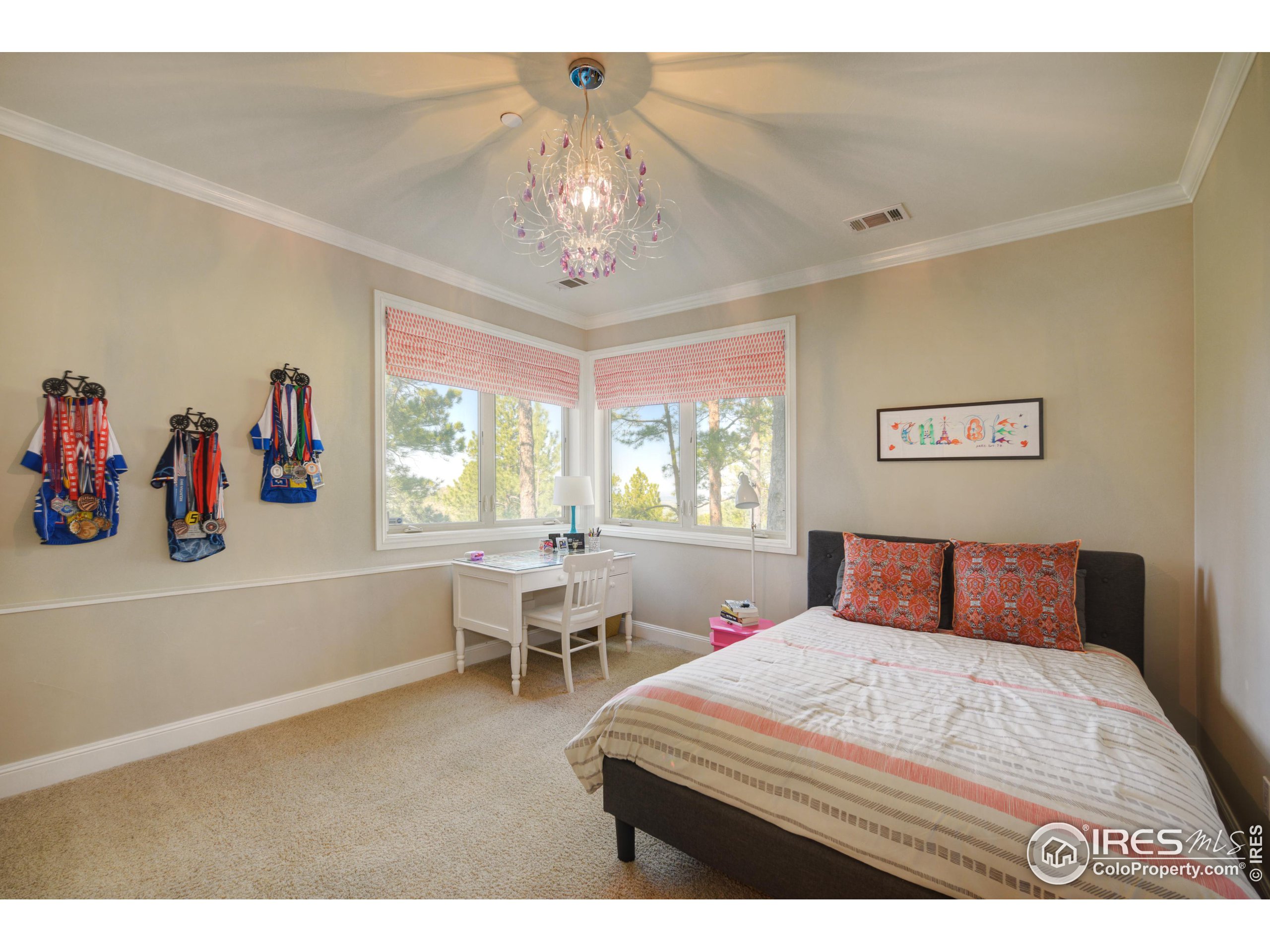 75 Alder Lane Boulder, CO 80304 - Photo 38 of 40 a bedroom with a large bed and a chandelier