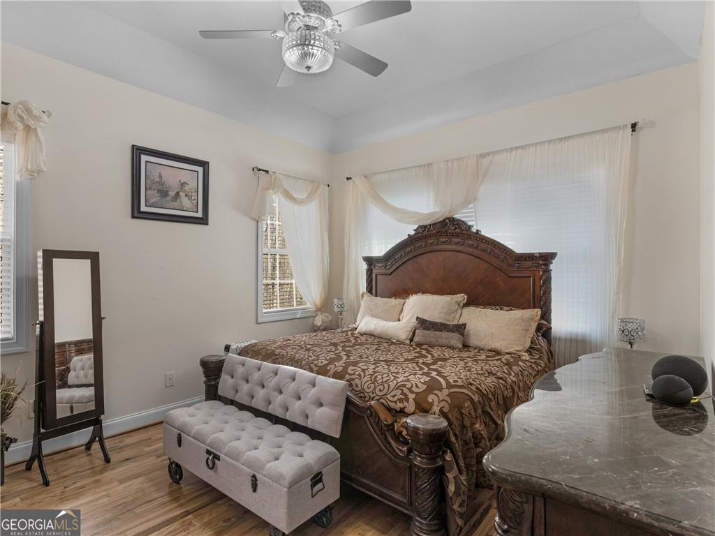 355 Parker Road Covington, GA 30014 - Photo 51 of 60 a bedroom with a bed and wooden floor