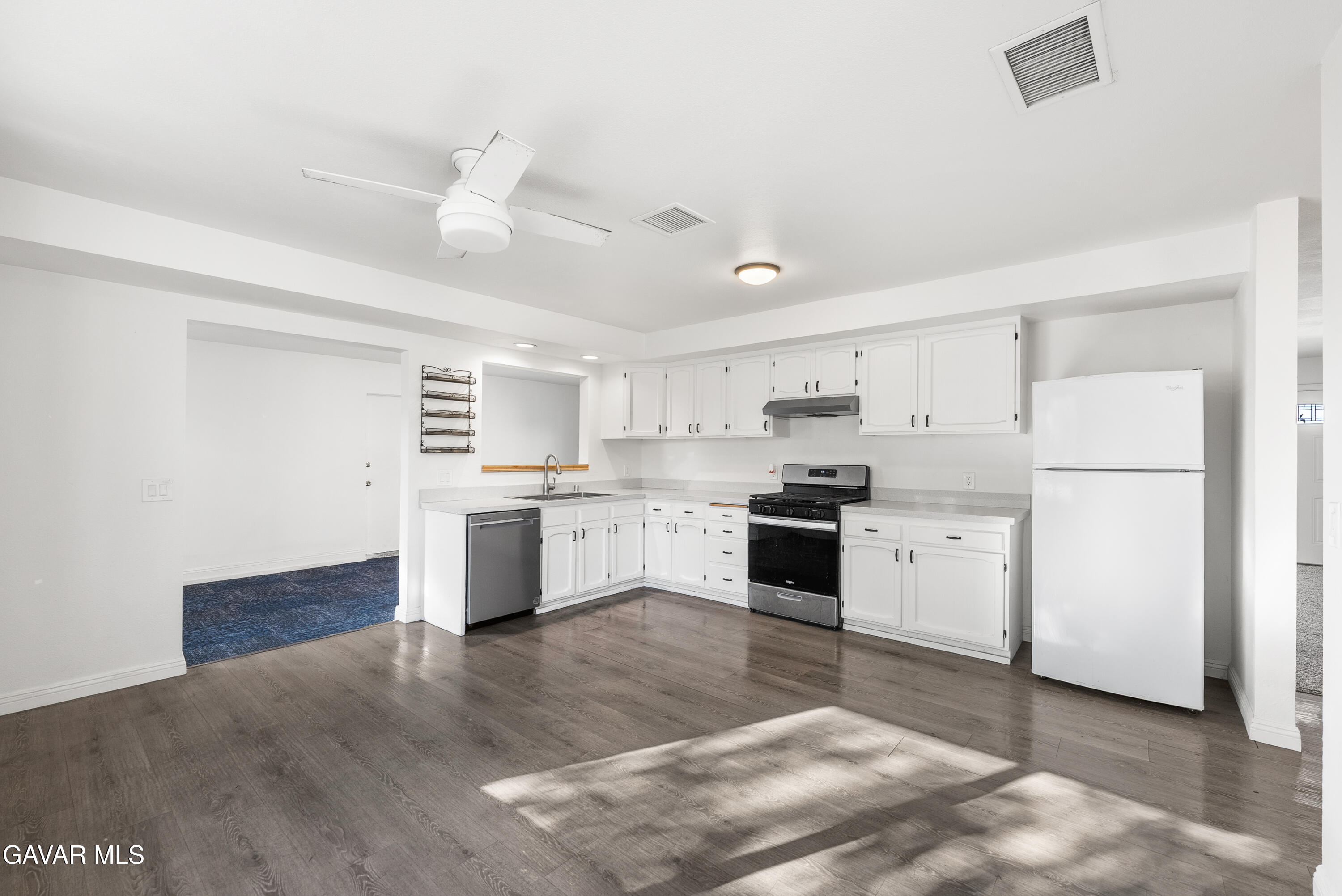 9459 East Ave T 2 Littlerock, CA 93543 - Photo 19 of 54 a kitchen with a white cabinets and white appliances
