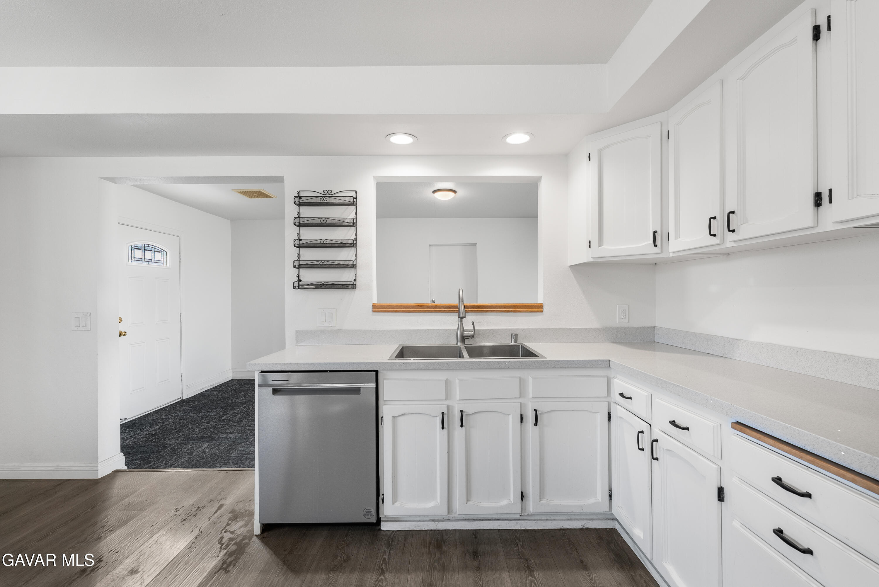 9459 East Ave T 2 Littlerock, CA 93543 - Photo 25 of 54 a kitchen with granite countertop white cabinets and white appliances