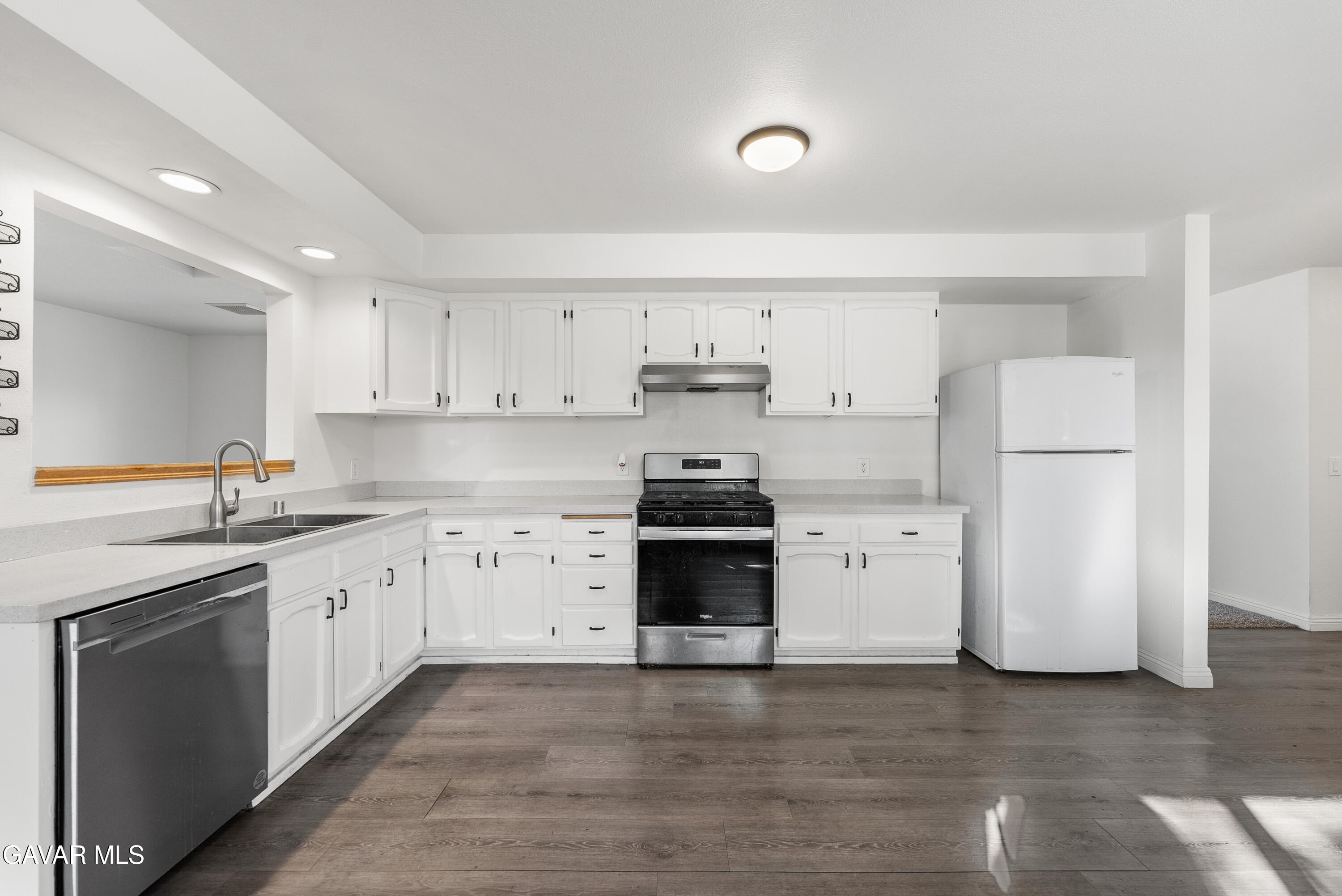 9459 East Ave T 2 Littlerock, CA 93543 - Photo 26 of 54 a kitchen with a white stove top oven and refrigerator