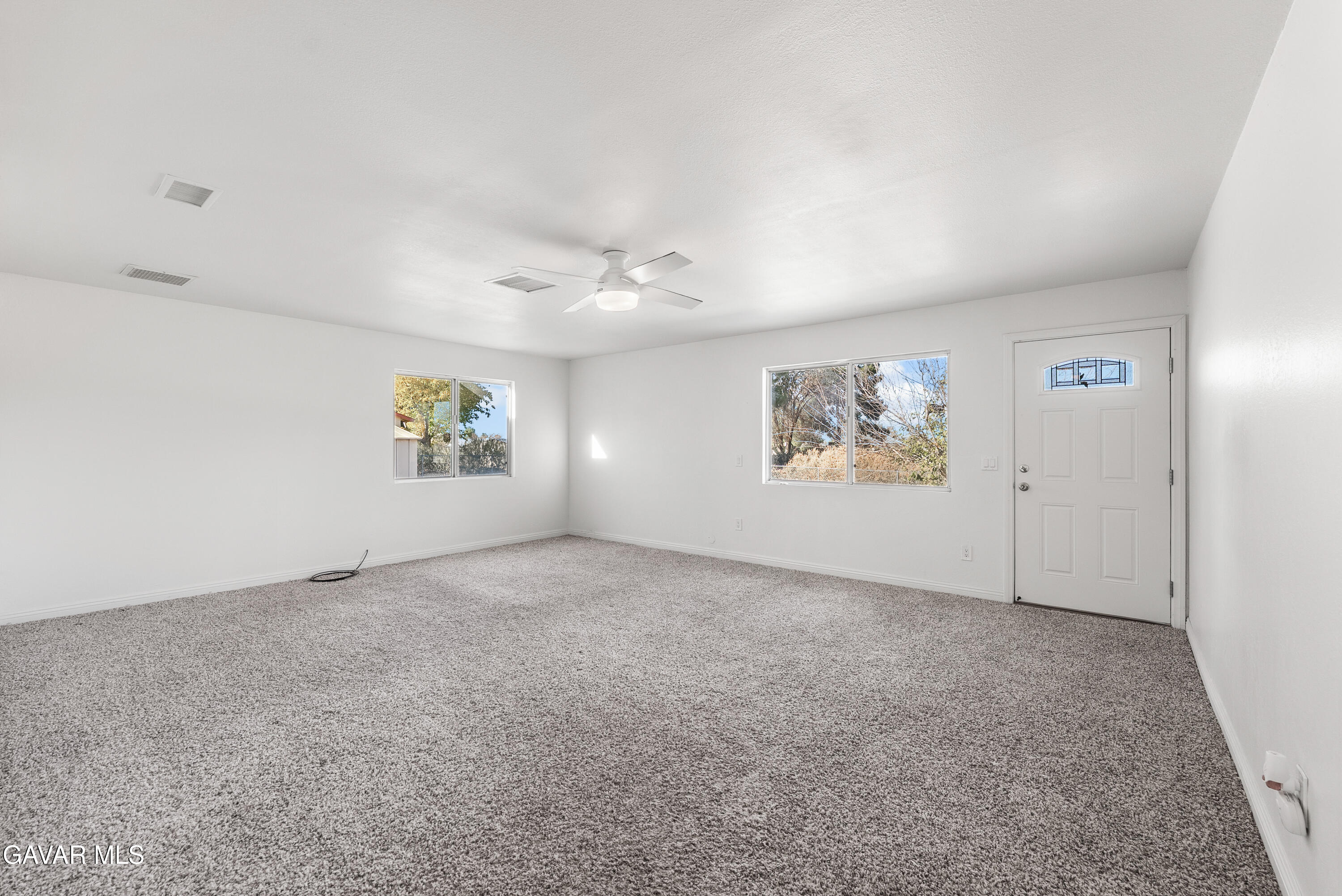 9459 East Ave T 2 Littlerock, CA 93543 - Photo 28 of 54 an empty room with windows and ceiling fan view