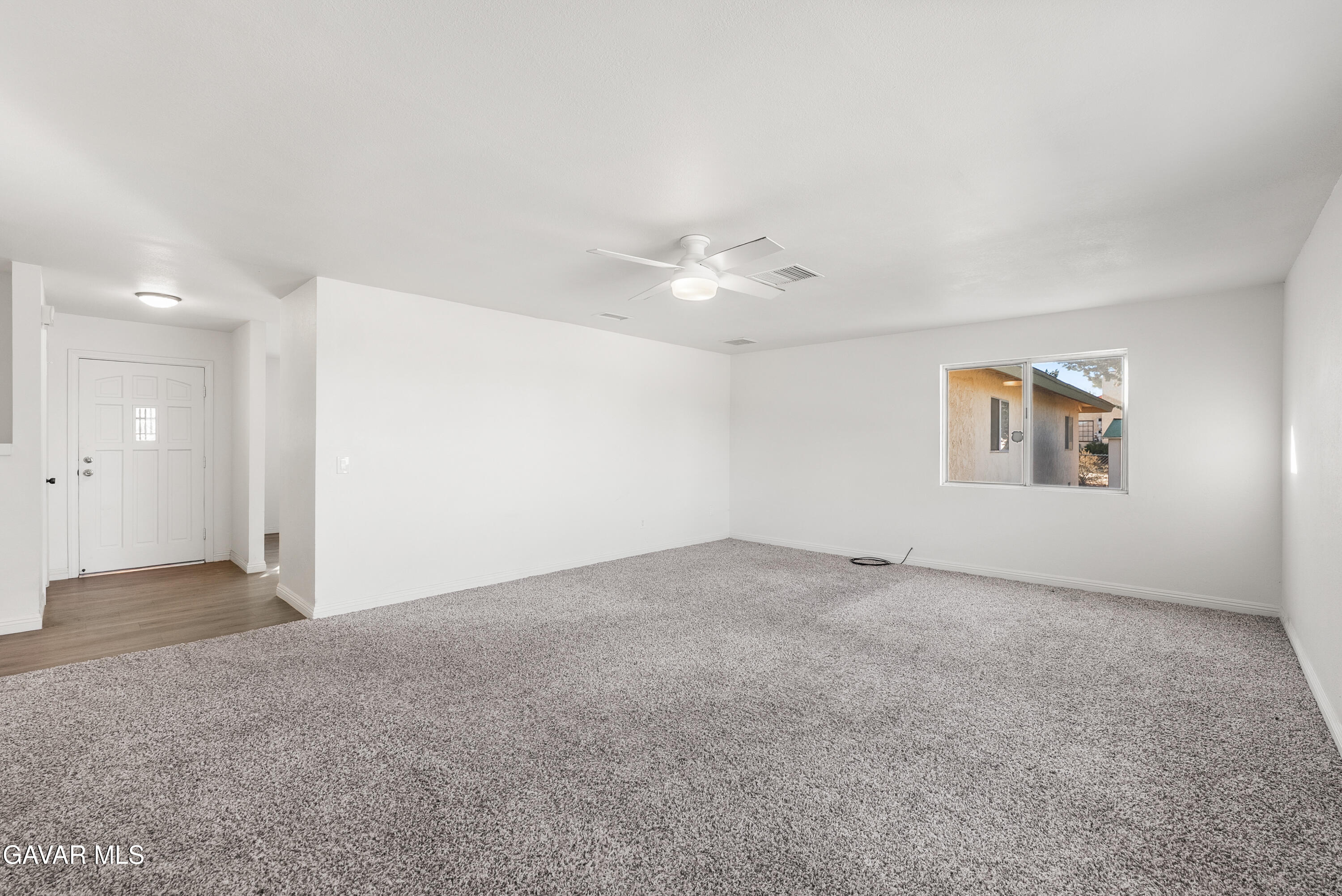 9459 East Ave T 2 Littlerock, CA 93543 - Photo 29 of 54 an empty room with a ceiling fan and a window