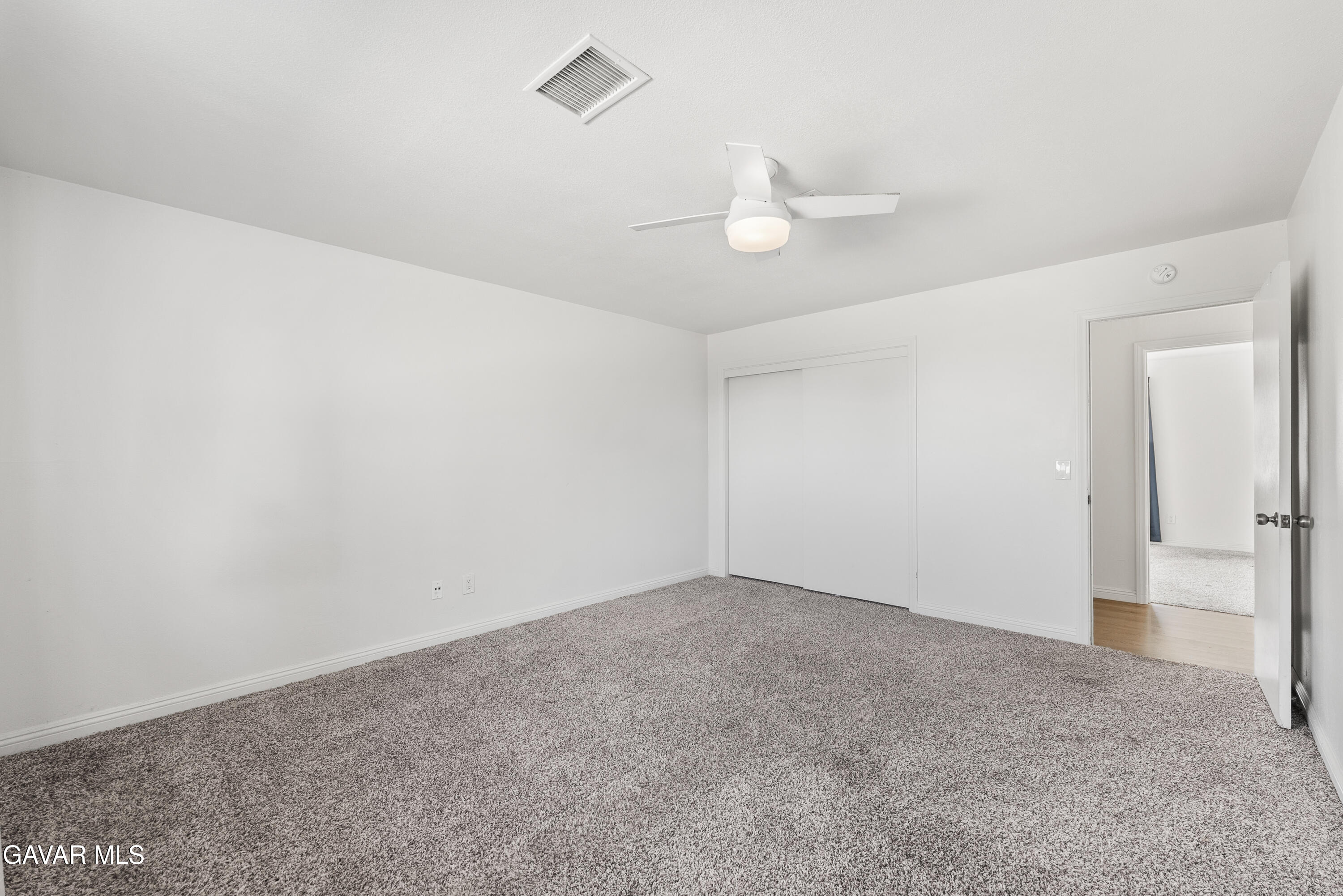 9459 East Ave T 2 Littlerock, CA 93543 - Photo 38 of 54 an empty room with a ceiling fan and a window