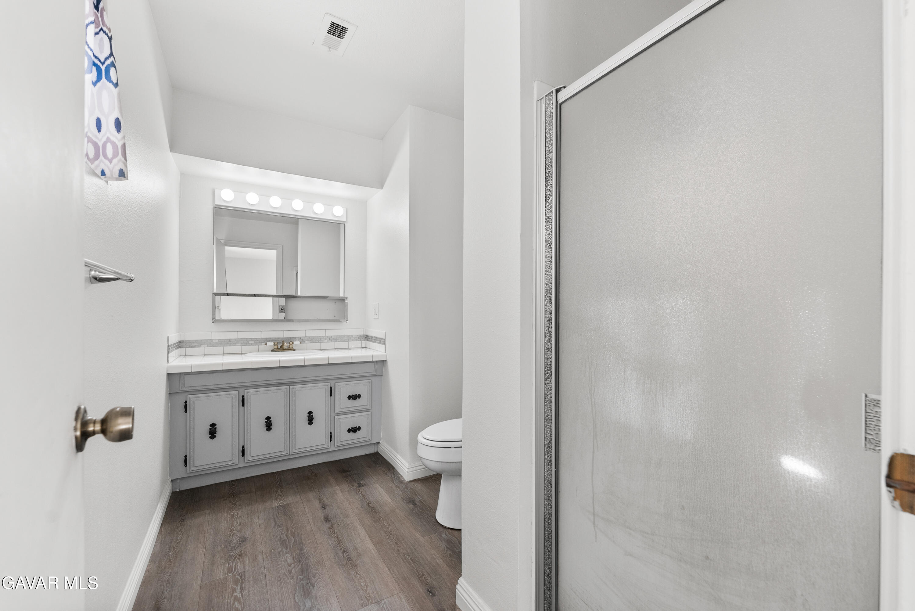 9459 East Ave T 2 Littlerock, CA 93543 - Photo 42 of 54 a bathroom with a double vanity sink mirror and toilet