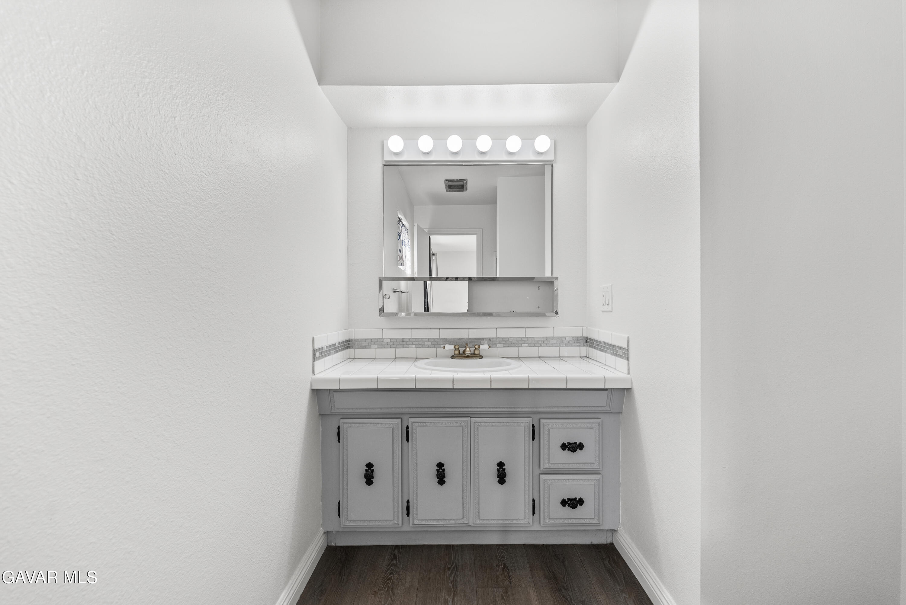 9459 East Ave T 2 Littlerock, CA 93543 - Photo 43 of 54 a view of a bathroom with a sink and a mirror