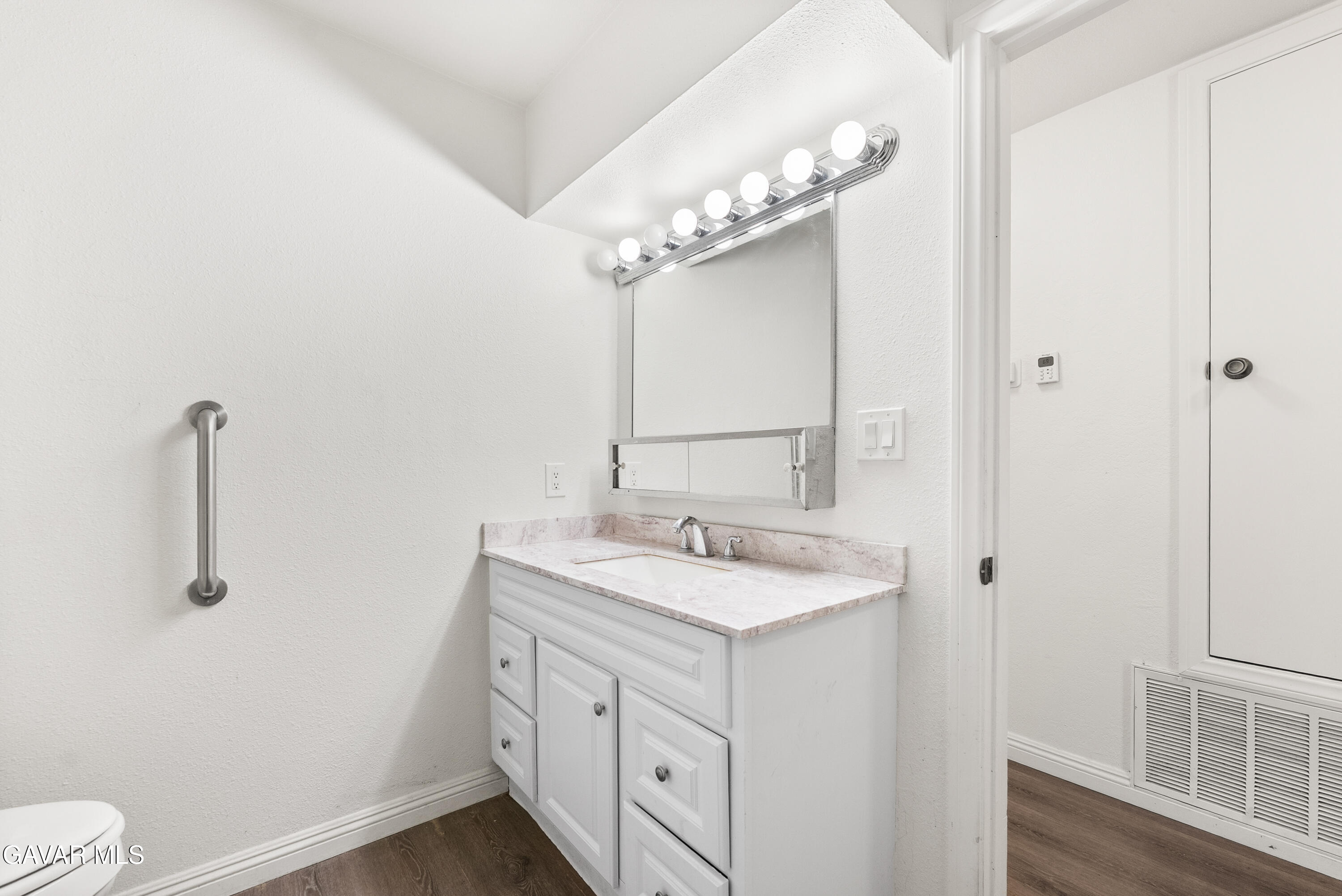 9459 East Ave T 2 Littlerock, CA 93543 - Photo 44 of 54 a view of bathroom with a sink mirror and toilet