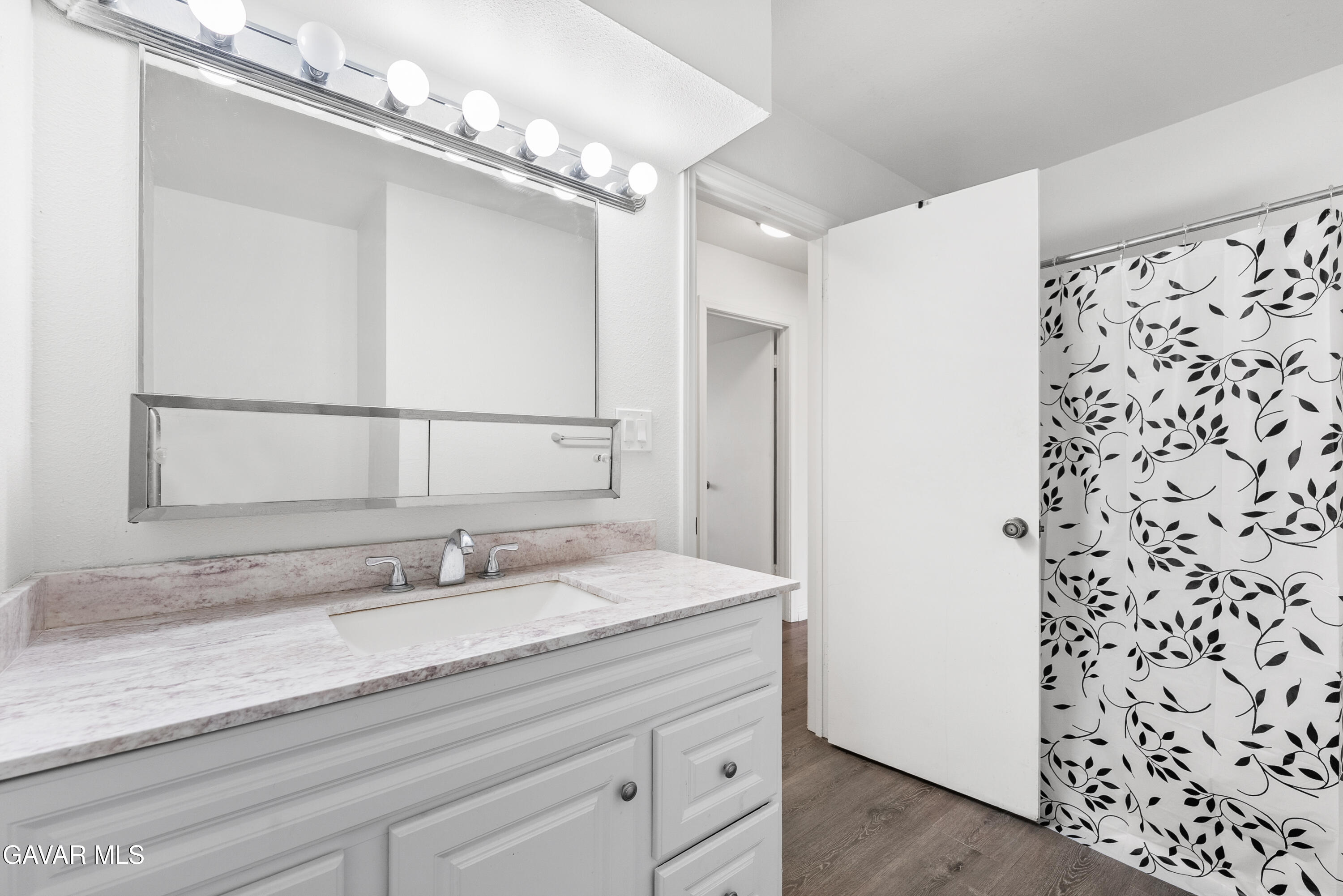 9459 East Ave T 2 Littlerock, CA 93543 - Photo 45 of 54 a bathroom with a sink a vanity and a mirror