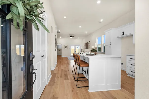 a kitchen with stainless steel appliances kitchen island hardwood floor and a sink