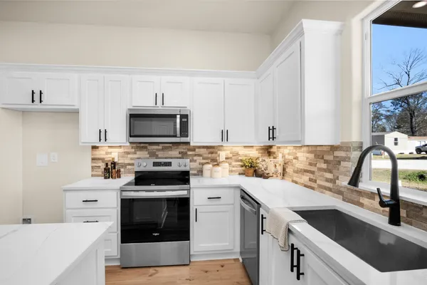 a kitchen with a sink stove and cabinets
