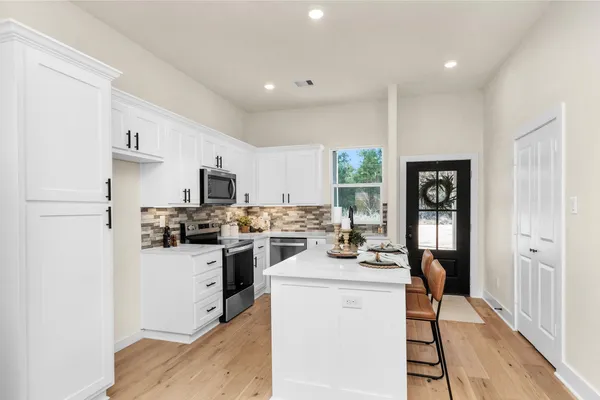 a kitchen with a sink a stove and refrigerator